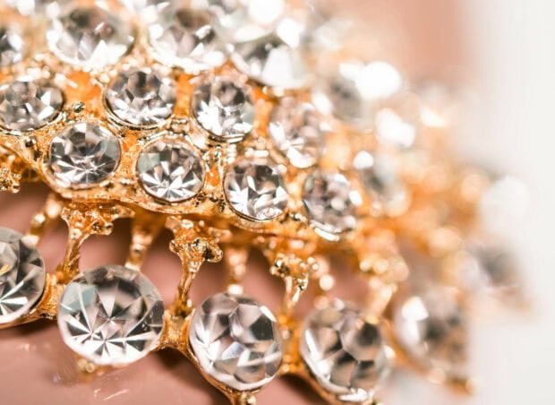 Close up of jewels reflecting light with sparkling details and golden setting
