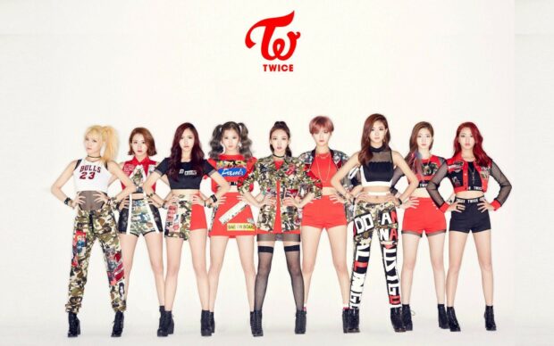 The popular K Pop group Twice poses confidently in stylish camo and red outfits