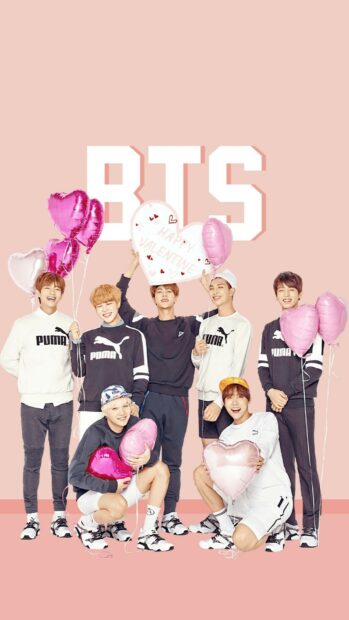 BTS holding pink heart shaped balloons with happy valentine sign on pink background