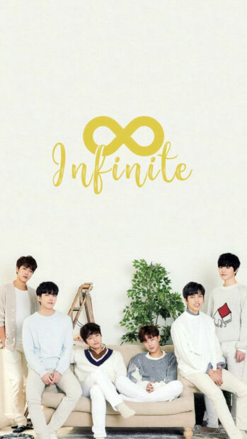 Infinite K Pop group sitting together in a cozy room with a green plant behind them
