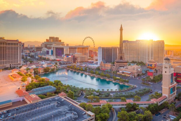 The Las Vegas Strip cityscape at sunset with the Eiffel Tower replica and Ferris wheel in view