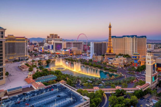 A vibrant view of Las Vegas Strip with the Eiffel Tower and fountains at dusk showcasing the cityscape and landmarks