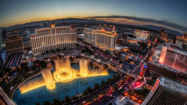 Las Vegas Strip fountain show at sunset with iconic hotels and cityscape in the background
