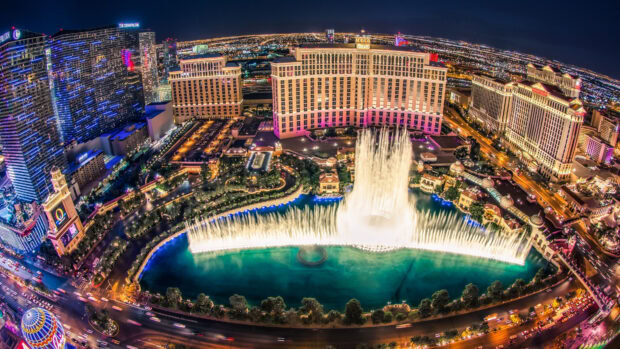 Night view of the Las Vegas Strip fountains with vibrant city lights and famous casino hotels