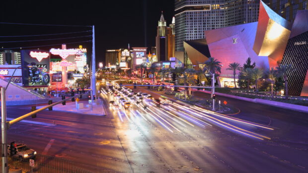 Night view of the Las Vegas Strip with illuminated buildings and busy traffic lights