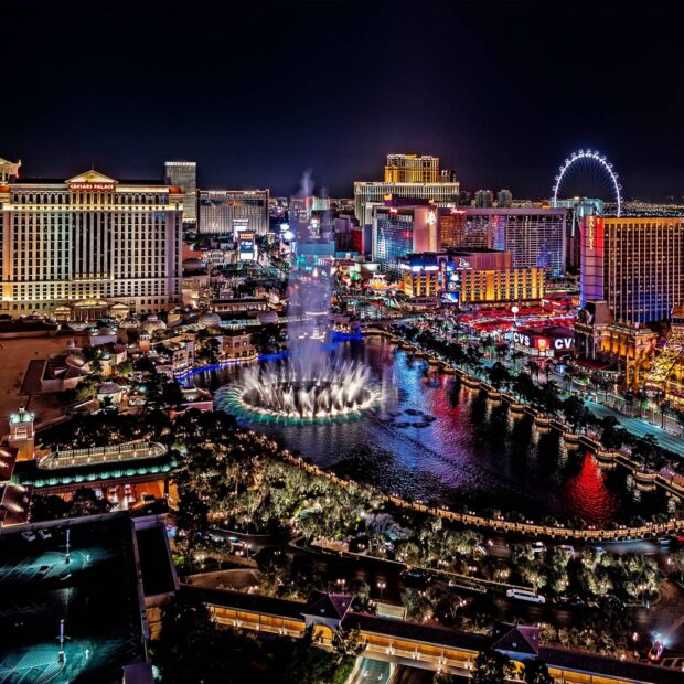 Nighttime view of Las Vegas Strip with fountains and colorful lights