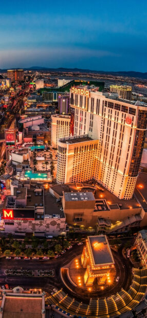 A stunning aerial view of Las Vegas Strip at dusk with vibrant city lights and famous landmarks