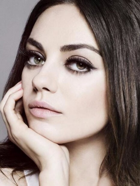 Close up portrait of Mila Kunis with natural makeup and thoughtful expression