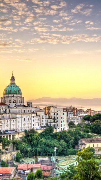 Historical architecture and green landscape in Naples at sunrise with clear sky