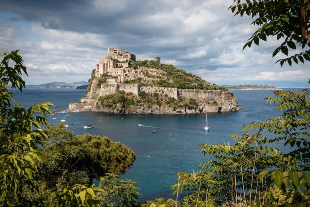 Historic castle and lush greenery on Naples coastline