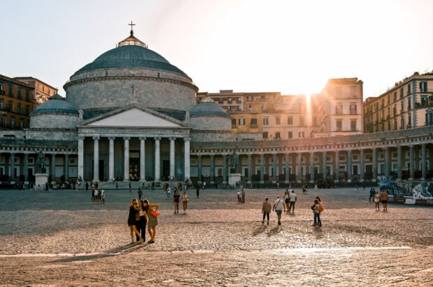 Historic Naples architecture with dome and columns at sunset in city square