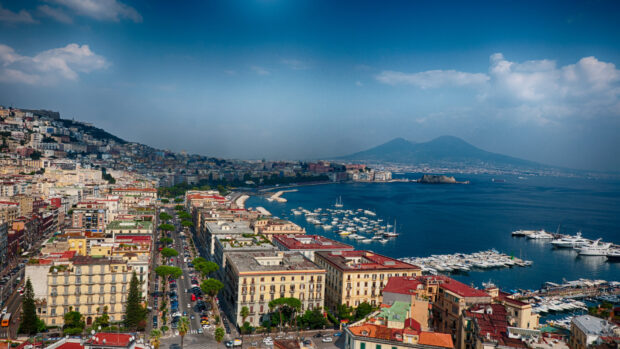 Scenic view of Naples coastline with cityscape and marina under clear blue sky