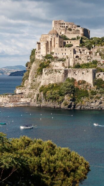 Ancient castle on a cliff overlooking the sea in Naples landscape