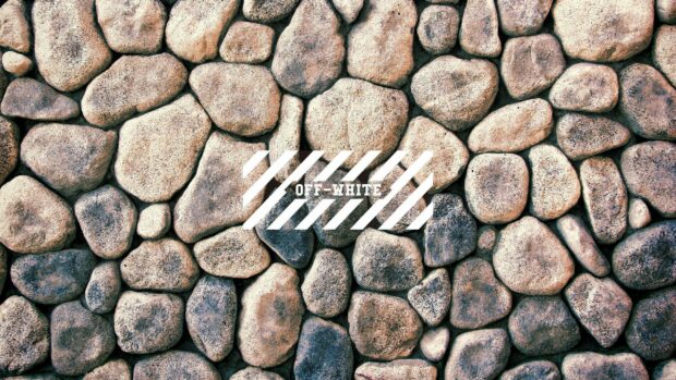 Close up of off white logo on natural stone pattern background