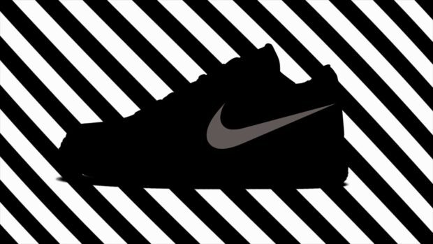 Black silhouette of Off White sneaker with grey swoosh on striped background