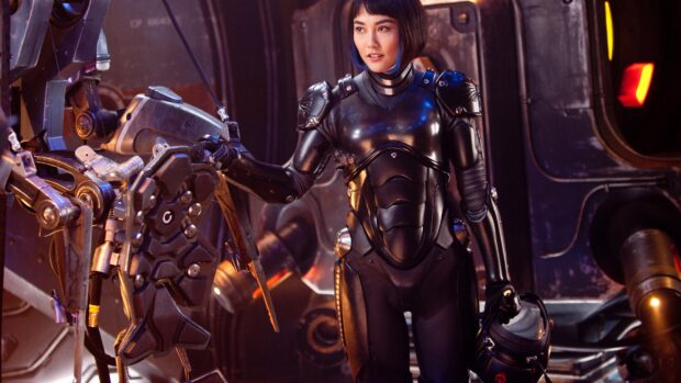 Female pilot operating a Pacific Rim mech suit in a high tech environment