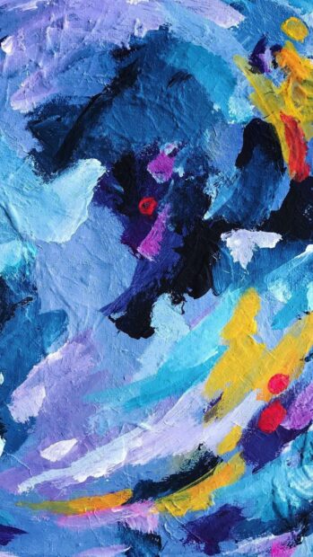 Abstract paint strokes in vibrant blues and purples with hints of yellow and red on canvas texture
