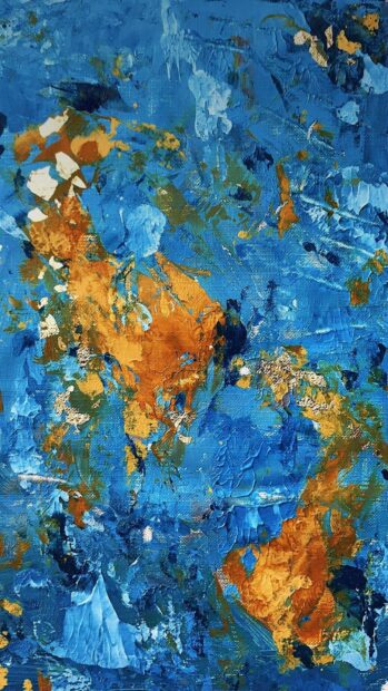 Abstract paint with vibrant blue and orange textured strokes on canvas