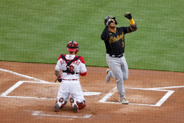 Pittsburgh Pirates player celebrating near home plate with catcher in baseball game
