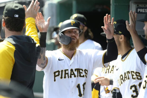 Pittsburgh Pirates player celebrating with teammates after a play in the dugout