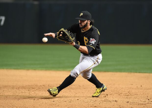 Pittsburgh Pirates player fielding a ground ball during a baseball game