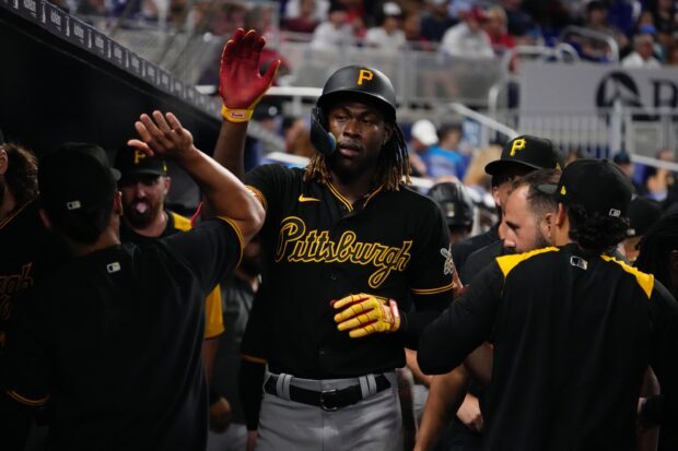 Pittsburgh Pirates player high fiving teammates after a successful play in a game