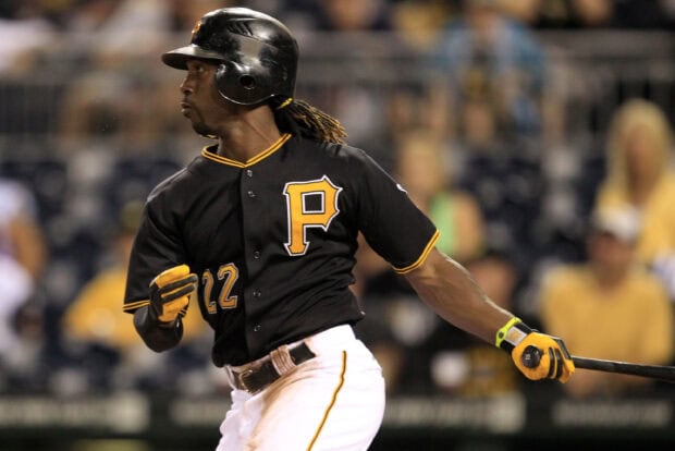 Pittsburgh Pirates player wearing black uniform hitting a baseball during a game