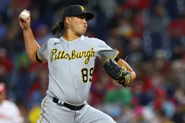 A Pittsburgh Pirates player pitching during a baseball game with focus on the player
