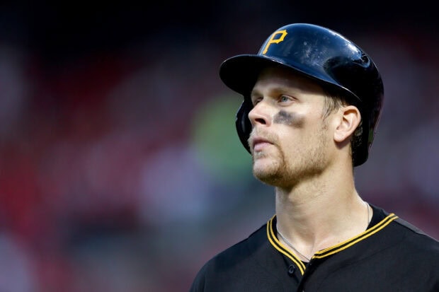 A close up of a Pittsburgh Pirates player wearing a helmet with a P logo and eye black looking focused