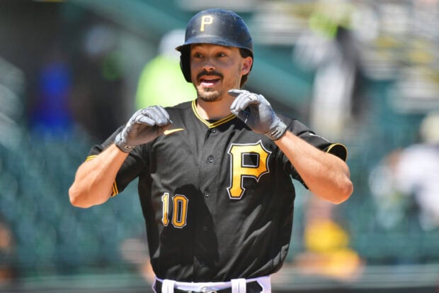 Baseball player wearing Pittsburgh Pirates uniform with number 10 on a sunny baseball field