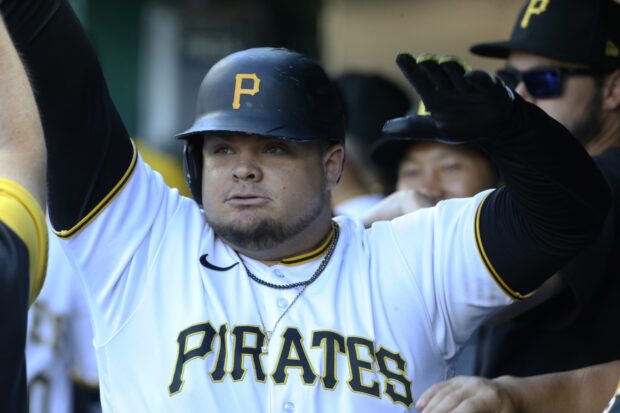 Pittsburgh Pirates player raising hands in celebration during game in jersey