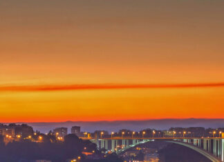 Beautiful Portugal cityscape at sunset showing river and historic buildings illuminated at night