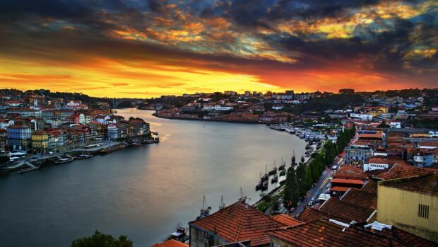 Vibrant Portugal cityscape with river and sunset sky in high definition quality