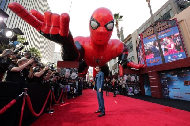 A man standing on the red carpet with spider cosplay balloon at the red carpet event