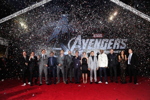 The Avengers cast celebrating on a red carpet with confetti falling at the world premiere event