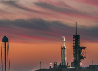 SpaceX Falcon Heavy rocket ready for launch at sunset with vivid sky colors
