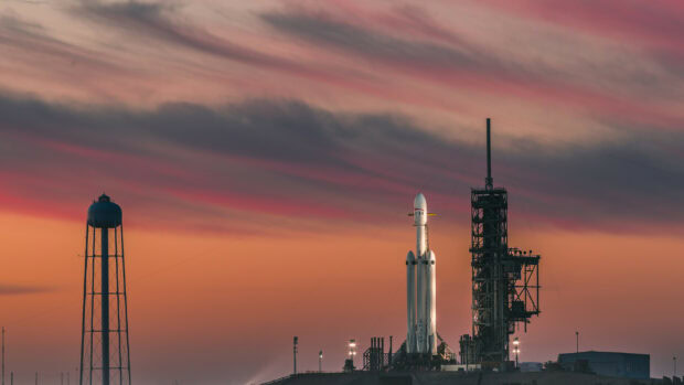 SpaceX Falcon Heavy rocket ready for launch at sunset with vivid sky colors
