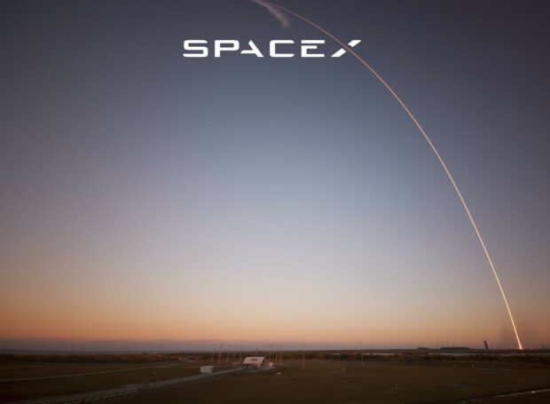 A spacex rocket launch trajectory captured over the horizon at sunset