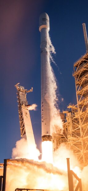 Falcon Nine rocket launch with steam and flames against clear sky