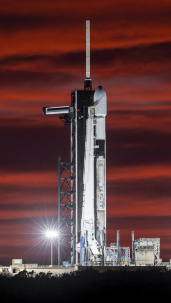 SpaceX rocket on launch pad during dramatic sunset with red sky