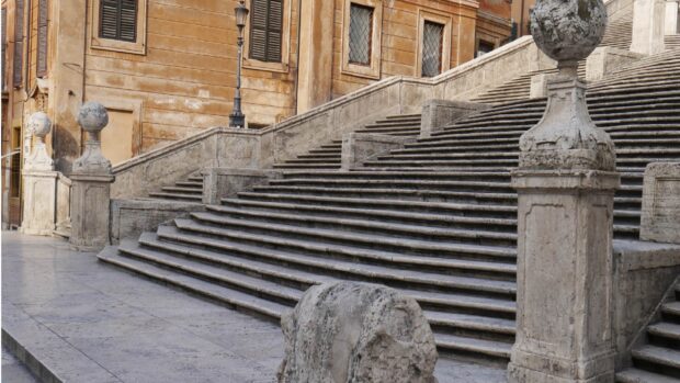 Historic Spanish Steps stone staircase in Rome with detailed architecture and statues