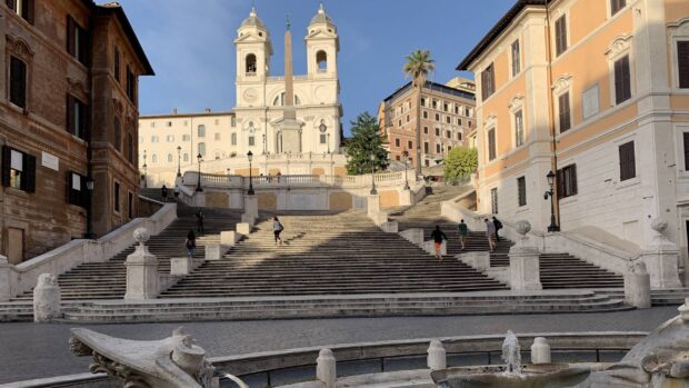 People walking on the Spanish Steps Rome with historic buildings in the background