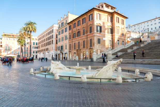 The Spanish Steps with fountain and historic buildings in Rome cityscape