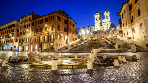 Early evening view of the Spanish Steps Rome with historic buildings and a fountain in front