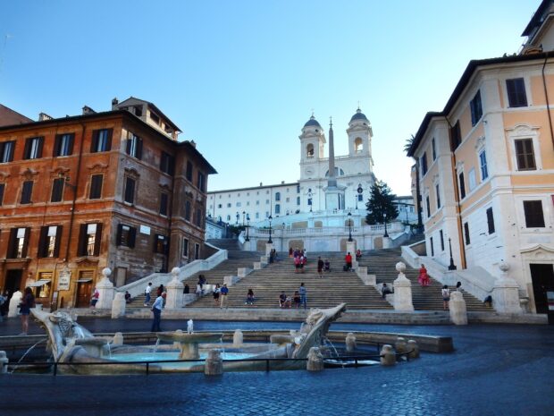 The Spanish Steps in Rome featuring historic architecture and a lively square