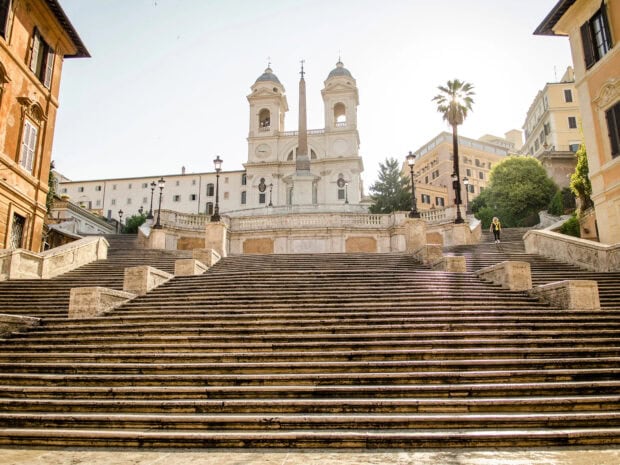 Historic Spanish Steps in Rome with bright morning light and clear sky