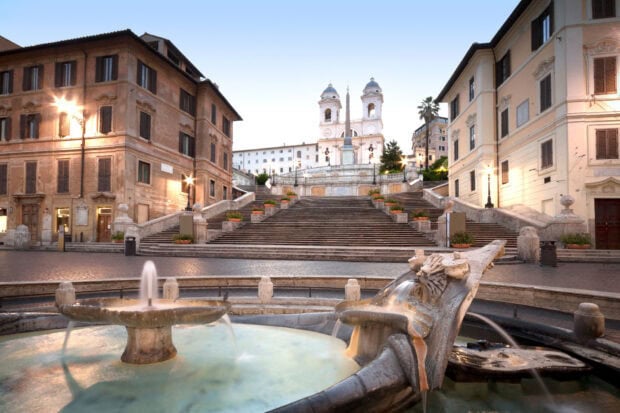 Historic Spanish Steps Rome with fountain and old buildings in clear daylight