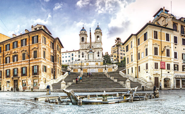 Historic Spanish Steps with people and old buildings in Rome city center