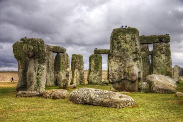 Ancient Stonehenge monument with large standing stones under cloudy sky