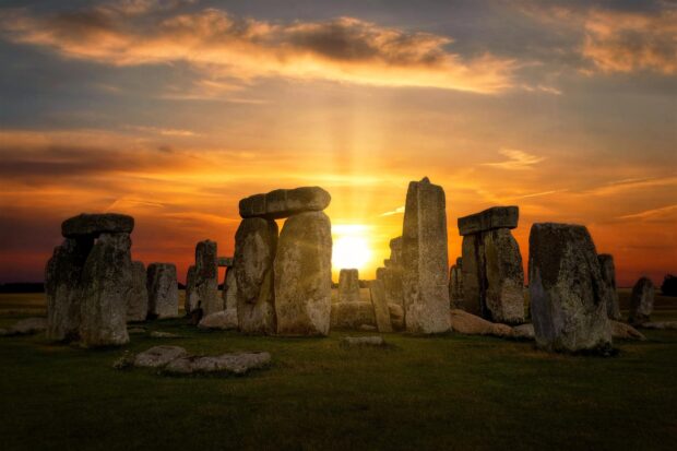 Ancient stonehenge monument with glowing sunset in the background